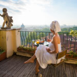 Woman traveling in Rome, seated near historic architecture