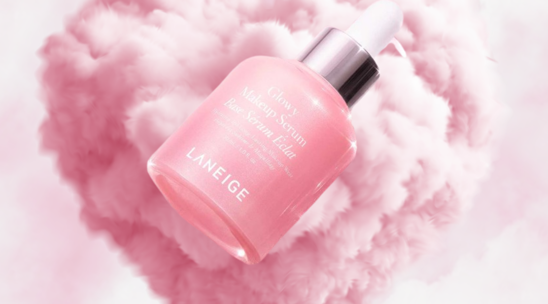 Laneige Glowy Makeup Serum floating in pink cloud heart background with soft luminous glow