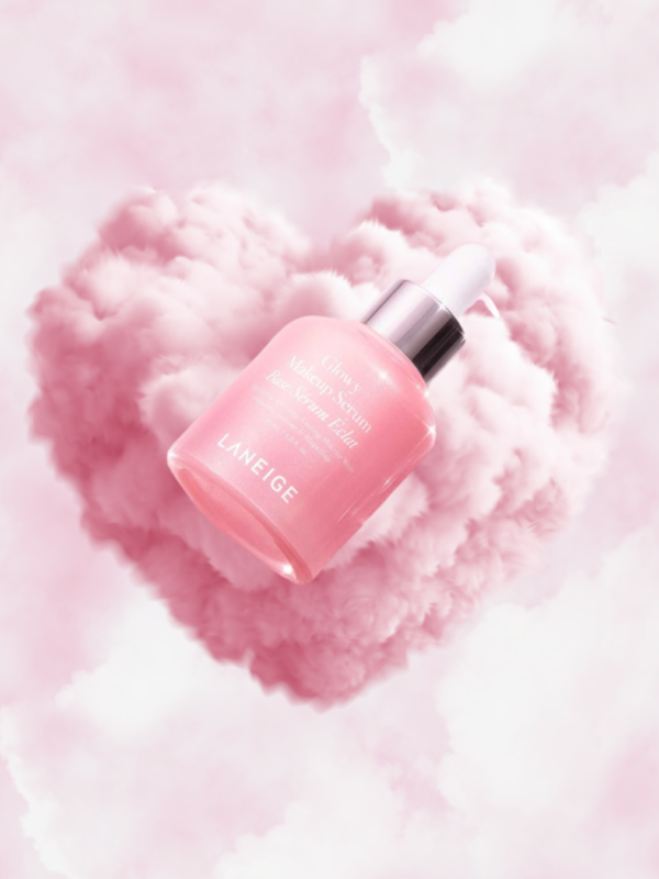 Laneige Glowy Makeup Serum floating in pink cloud heart background with soft luminous glow