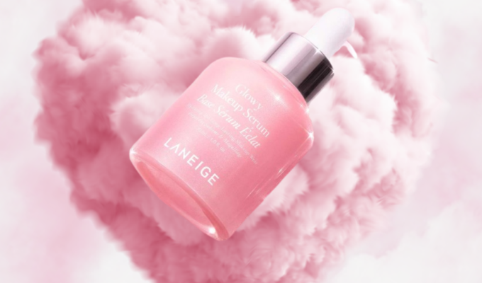 Laneige Glowy Makeup Serum floating in pink cloud heart background with soft luminous glow