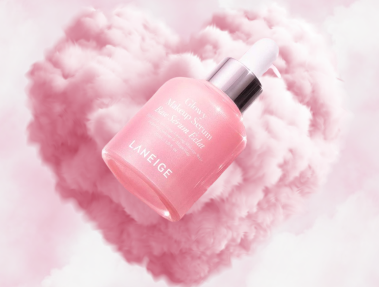 Laneige Glowy Makeup Serum floating in pink cloud heart background with soft luminous glow
