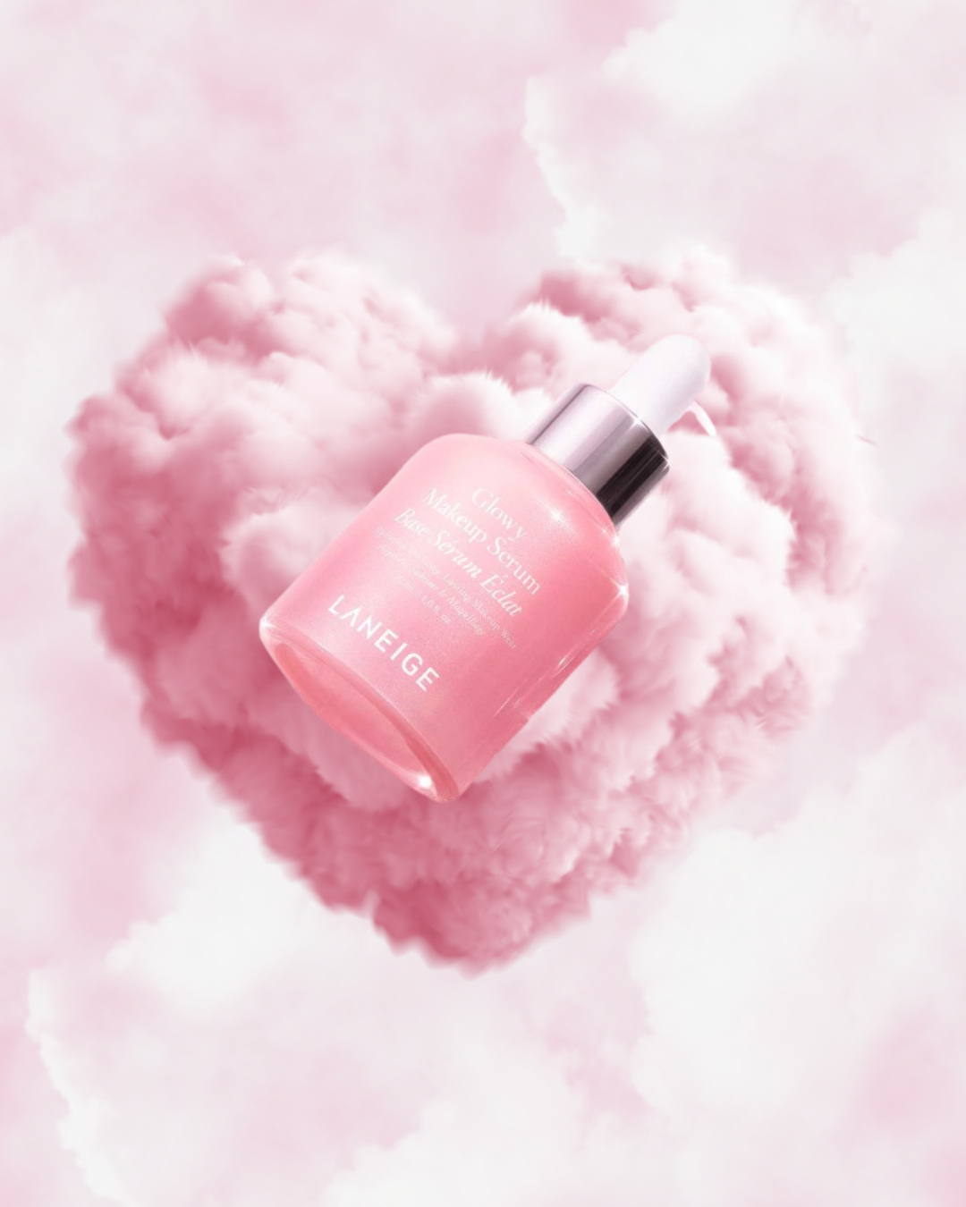 Laneige Glowy Makeup Serum floating in pink cloud heart background with soft luminous glow