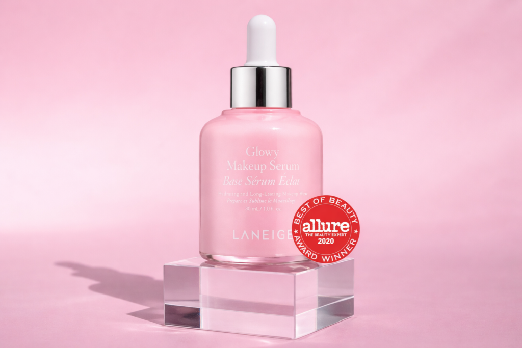 Laneige Glowy Makeup Serum bottle on pink background with luminous finish